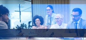 Four people engaged in a friendly meeting, gathered around a table. They appear to be having a lively discussion, with engaged expressions and gestures. One person in the center is likely the main focus of the meeting, as the others are attentively listening to what they have to say. The atmosphere seems welcoming and collaborative, fostering an environment for productive interactions and idea sharing